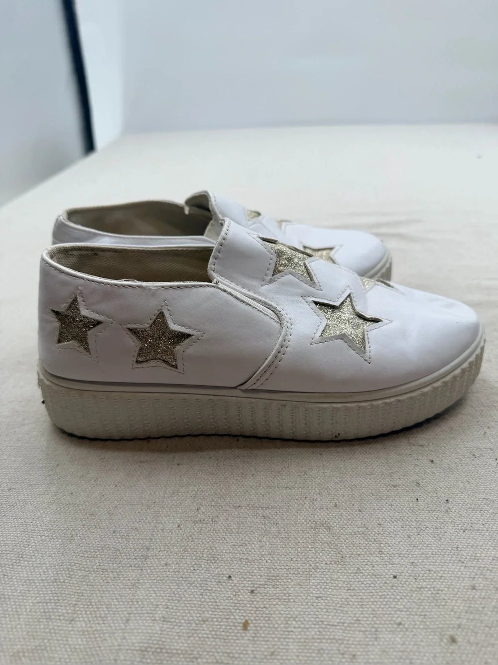 ' White Slip-On Sneakers with Gold Star Accents